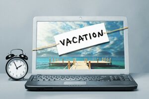 Laptop with Vacation Note